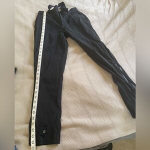 Athleta black pants with zipper and button closure on the legs.